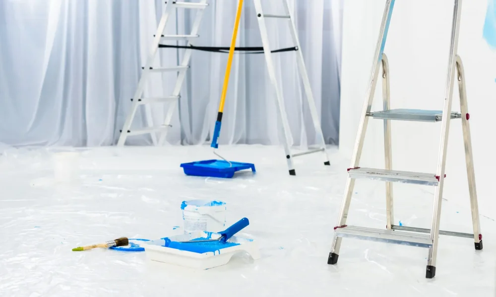 ladders-and-paint-roller-brushes-in-blue-paint-in-2024-11-18-12-49-48-utc-1-scaled